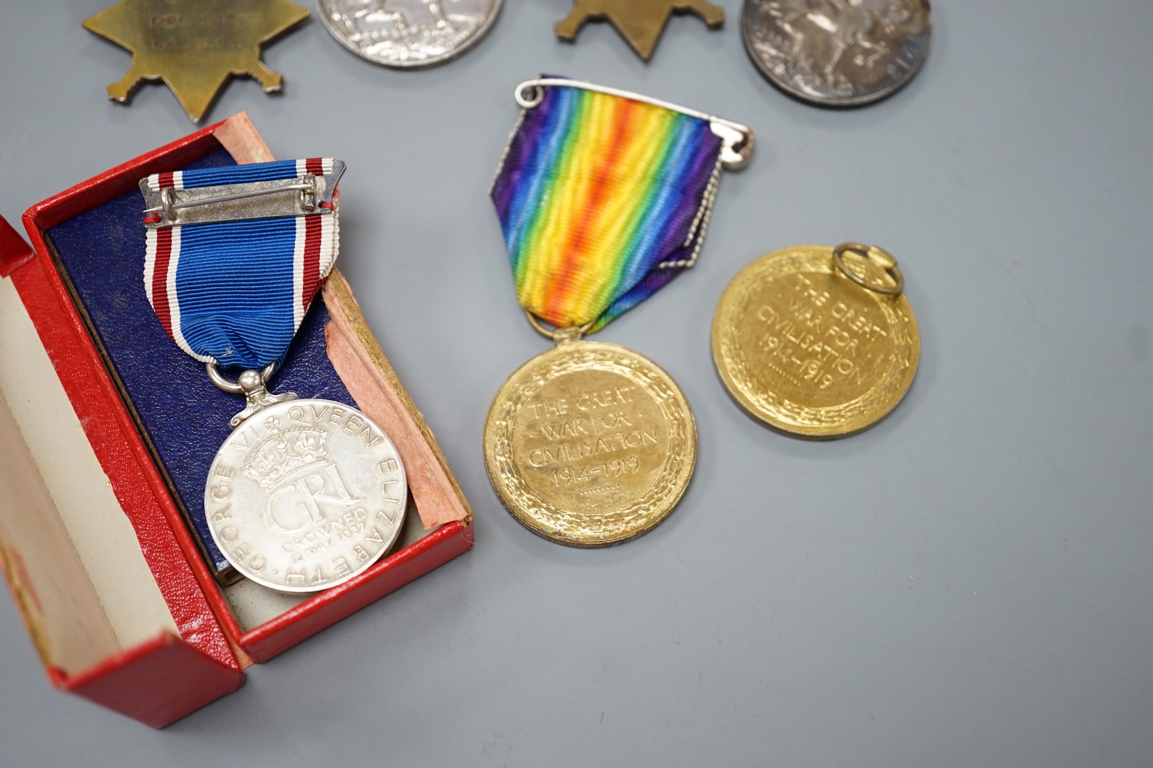 WWI and later medals - Mons star (with bar and rosette) trio to 6480 PTE. F. TURNER 1/DNS., a Mons star pair to L-8608 CPL. E.T. DYER. 1/R W. KENT R., an unnamed Great War medal and a boxed George VI coronation medal (7)